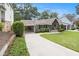 Charming home with mature landscaping, a porte-cochere, and rocking chair front porch at 3013 Surrey Ln, Atlanta, GA 30341