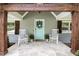 Inviting front porch with rocking chairs, a colorful front door, and charming wood details at 3013 Surrey Ln, Atlanta, GA 30341