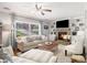 Cozy living room with a stone fireplace, built-in bookshelves, and large windows for natural light at 3013 Surrey Ln, Atlanta, GA 30341