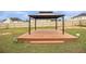 Backyard with a wooden deck and metal gazebo and wood fence in the background at 4207 Fortune Pt, South Fulton, GA 30349