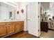 Bathroom with double sinks, wood cabinets, and a door to the bedroom at 4207 Fortune Pt, South Fulton, GA 30349