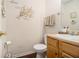 Cozy half bathroom with wood cabinets and modern decor at 4207 Fortune Pt, South Fulton, GA 30349