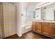 Bright bathroom with wood floors, tub, shower, and double sink vanity at 4207 Fortune Pt, South Fulton, GA 30349