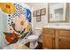 Cozy bathroom with bright shower curtain, floral decor, and wood-look floors at 4207 Fortune Pt, South Fulton, GA 30349
