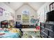 Bright bedroom with vaulted ceilings, arched window, and colorful decor at 4207 Fortune Pt, South Fulton, GA 30349