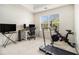 Bright bonus room with workout equipment and a computer setup at 4207 Fortune Pt, South Fulton, GA 30349