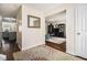Inviting entryway with hardwood floors, decorative rug, and views of the living room and kitchen at 4207 Fortune Pt, South Fulton, GA 30349