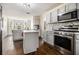 Modern kitchen with stainless steel appliances, gray cabinets, an island, and hardwood floors at 4207 Fortune Pt, South Fulton, GA 30349