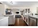 Open kitchen featuring gray cabinets, stainless steel appliances, and a view into the living room at 4207 Fortune Pt, South Fulton, GA 30349