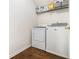 Laundry room featuring laminate wood floor and white washer and dryer at 4207 Fortune Pt, South Fulton, GA 30349