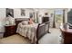 A well decorated main bedroom with artwork, dark furniture, and natural light at 4207 Fortune Pt, South Fulton, GA 30349