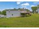 Back exterior featuring a raised deck overlooking the lawn at 4665 Big Valley Rd, Stone Mountain, GA 30083