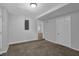 Cozy finished basement featuring neutral walls, plush carpeting, and a white door at 4665 Big Valley Rd, Stone Mountain, GA 30083