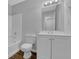 Bathroom with tub and shower, toilet, and vanity with mirror and cabinet at 4665 Big Valley Rd, Stone Mountain, GA 30083
