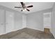 Spacious carpeted bedroom with two closets, ceiling fan, and ensuite bathroom at 4665 Big Valley Rd, Stone Mountain, GA 30083