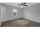 Bedroom with neutral gray walls, a ceiling fan, and a window offering natural light at 4665 Big Valley Rd, Stone Mountain, GA 30083