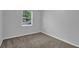 Bedroom with carpet, window with blinds, and electrical outlets on the walls at 4665 Big Valley Rd, Stone Mountain, GA 30083