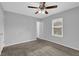 Bright bedroom with ceiling fan, carpet, and a window with view to the outside at 4665 Big Valley Rd, Stone Mountain, GA 30083