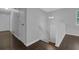 Hallway with a staircase, hardwood floors, and neutral gray colored walls at 4665 Big Valley Rd, Stone Mountain, GA 30083