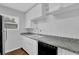 Bright kitchen with white cabinets, granite countertops, and stainless steel appliances at 4665 Big Valley Rd, Stone Mountain, GA 30083