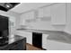 Well-lit kitchen featuring white cabinets and modern appliances at 4665 Big Valley Rd, Stone Mountain, GA 30083