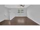 Spacious living room with hardwood floors, a modern ceiling fan, and great natural light at 4665 Big Valley Rd, Stone Mountain, GA 30083