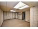 Finished basement with carpeted floor, paneled walls, and access to a storage or utility room at 615 Woodwork Way, Roswell, GA 30076