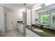 A bathroom with double vanity sinks and modern fixtures at 615 Woodwork Way, Roswell, GA 30076