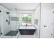 Modern bathroom featuring a sleek black soaking tub and a glass-enclosed shower at 615 Woodwork Way, Roswell, GA 30076
