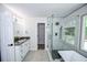 Bathroom with a modern glass-enclosed shower and a freestanding tub at 615 Woodwork Way, Roswell, GA 30076