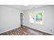 Bedroom with weathered-look wood flooring and natural light from the windows at 615 Woodwork Way, Roswell, GA 30076