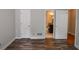 Spacious bedroom showcasing modern wood flooring and an open doorway to a bathroom at 615 Woodwork Way, Roswell, GA 30076