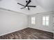 Bright bedroom with wood floors, tray ceiling, ceiling fan, and plantation shutters at 615 Woodwork Way, Roswell, GA 30076