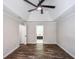 A bedroom featuring a tray ceiling with fan and a glimpse into an ensuite bathroom at 615 Woodwork Way, Roswell, GA 30076