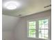 This bedroom has two large windows and neutral paint at 615 Woodwork Way, Roswell, GA 30076