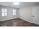 Bedroom featuring new floors, white shutters and a ceiling light at 615 Woodwork Way, Roswell, GA 30076