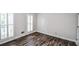 Bedroom with wood floors and white shuttered windows at 615 Woodwork Way, Roswell, GA 30076
