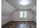 Bonus room featuring an angled ceiling, wood flooring and natural light at 615 Woodwork Way, Roswell, GA 30076