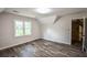 Bonus room featuring wood floors, angled ceilings and natural light from the window at 615 Woodwork Way, Roswell, GA 30076