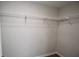 Walk-in closet featuring white wire shelving and wood floors at 615 Woodwork Way, Roswell, GA 30076