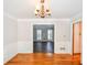 Elegant dining area featuring hardwood floors, a chandelier, and adjacent to a doorway at 615 Woodwork Way, Roswell, GA 30076