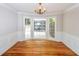 Charming dining room with hardwood floors, wainscoting, and a chandelier at 615 Woodwork Way, Roswell, GA 30076
