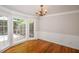 Charming dining area with natural light, hardwood floors and wainscoting detail at 615 Woodwork Way, Roswell, GA 30076