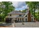 The rear exterior of this home features a brick chimney, a gazebo, a grill and a stone pathway at 615 Woodwork Way, Roswell, GA 30076
