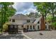 A house exterior features white siding, a brick chimney, outdoor deck, and a cozy gazebo at 615 Woodwork Way, Roswell, GA 30076