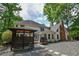 The house exterior features a white finish, a gazebo, a brick chimney and wooded surroundings at 615 Woodwork Way, Roswell, GA 30076