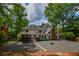 Back exterior view of a home with white siding, a brick chimney, gazebo and crushed gravel ground cover at 615 Woodwork Way, Roswell, GA 30076
