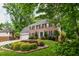 Charming brick home with a well-manicured lawn and landscape at 615 Woodwork Way, Roswell, GA 30076