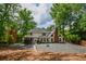 The rear exterior of this house features a gazebo, a brick chimney, and a stone pathway at 615 Woodwork Way, Roswell, GA 30076