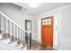 Elegant foyer features a stylish wooden door, slate floors, and staircase at 615 Woodwork Way, Roswell, GA 30076